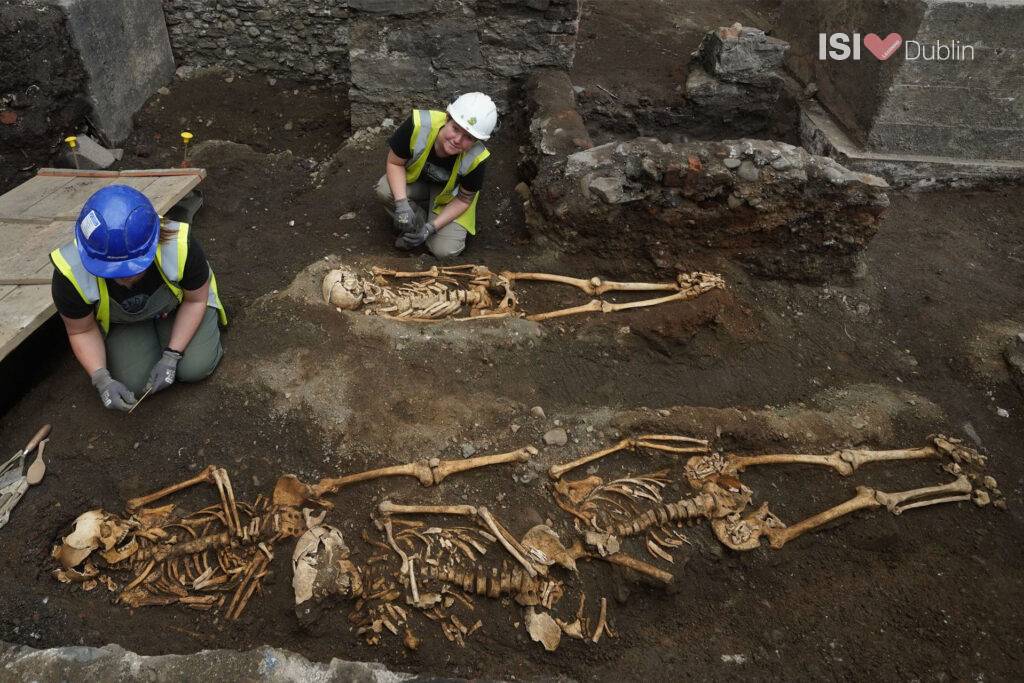 Photograph by Brian Lawless showing archaeologists examining skeletal remains at the site of St Mary’s Abbey