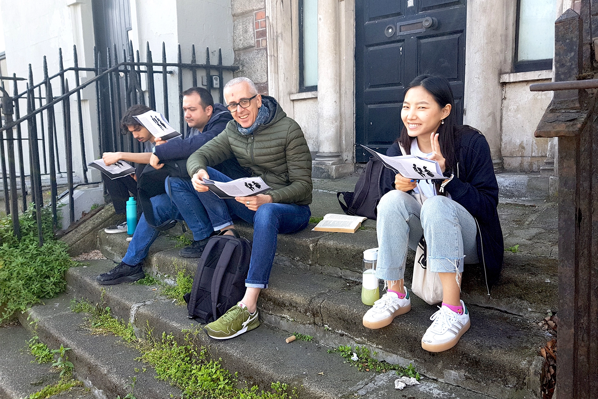 ISI students reading a story from James Joyce's Dubliners in situ at the House of the Dead, Usher's Island, Dublin, with their teacher, Edia.