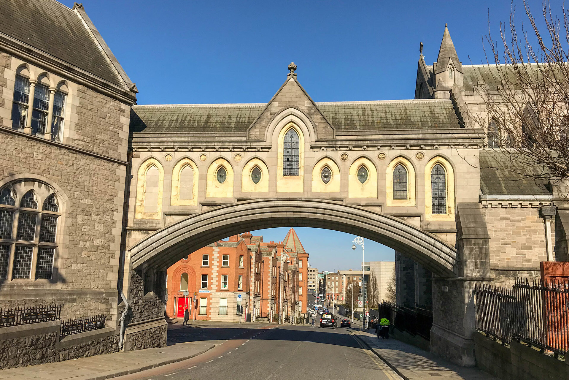 Dublin, Ireland. Landscape view of an archway which connects Christ Church Cathedral on the right with the Synod Hall on the left. The Synod Hall houses the Dublinia Viking Museum